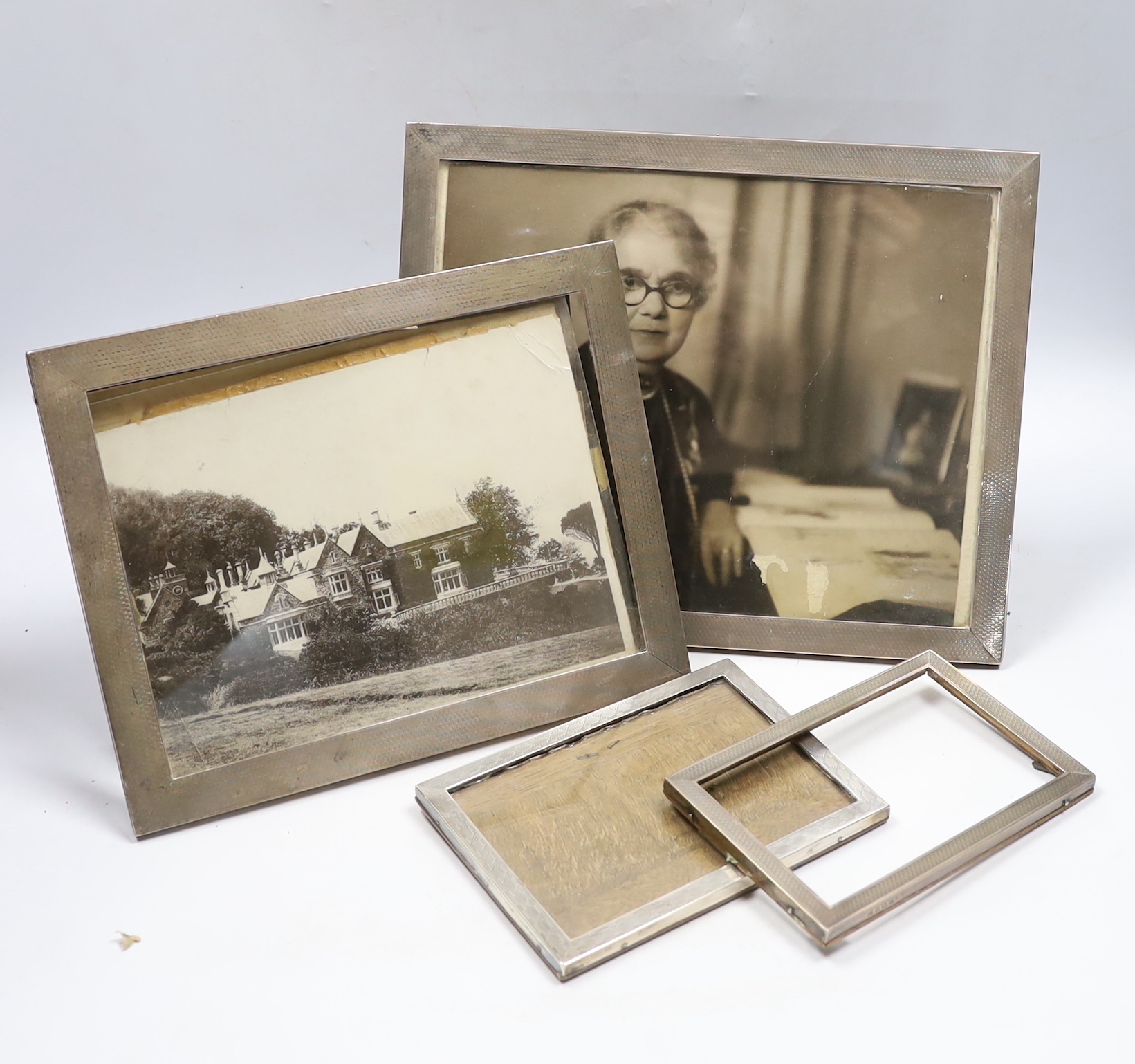 Four assorted early to mid 20th century silver mounted rectangular photograph frames, largest 28.6cm.